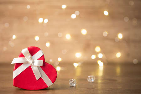 Red gifts tied with a white satin ribbon bow.の写真素材