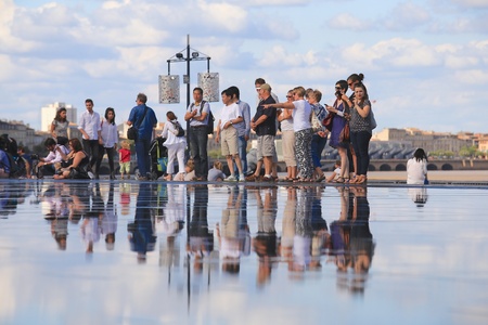 Bordeaux, France - 4 August, 2015 : Bordeaux water mirror full of people in one hottest summer days, having fun in the waterの素材