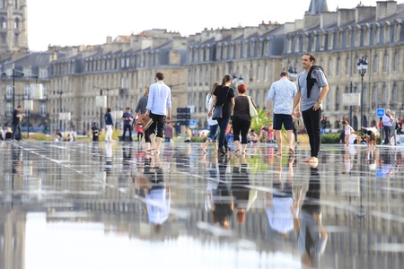 Bordeaux, France - 4 August, 2015 : Bordeaux water mirror full of people in one hottest summer days, having fun in the waterの素材