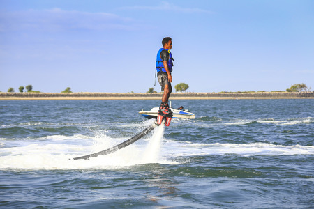 Sanur, Bali, Indonesia - August 10, 2016 :  An unidentified guy is playing with a new water sport called fly board in Bali, Indonesiaのeditorial素材