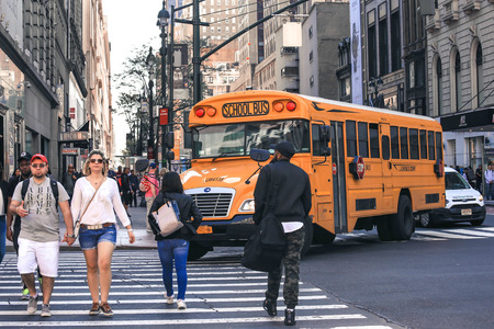 NEW YORK, USA - APRIL 15, 2016 : Yellow school school bus in Manhattan on his way to picking up pupilsのeditorial素材