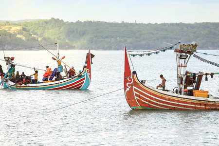 BALI, INDONESIA - AUGUST 13, 2016 : Fishermen on local fishing boat at sunset. Bali , Indonesiaのeditorial素材