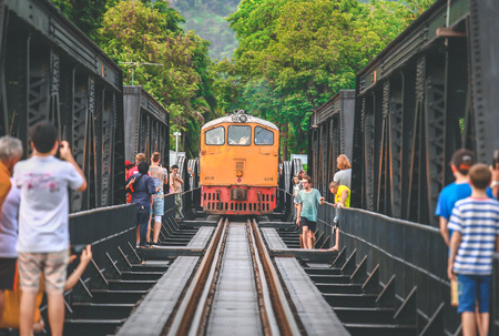 KANCHANABURI, THAILAND - JULY 9, 2016: Tourists taking pictures the train on the bridge over the river Kwai in Kanchanaburi, Thailand. This bridge is famous for its history in second world warのeditorial素材