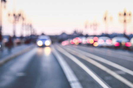 Vintage style image of blurred street bokeh with colorful lights in evening time at Pont de Pierre bridge, Bordeaux, Franceの写真素材