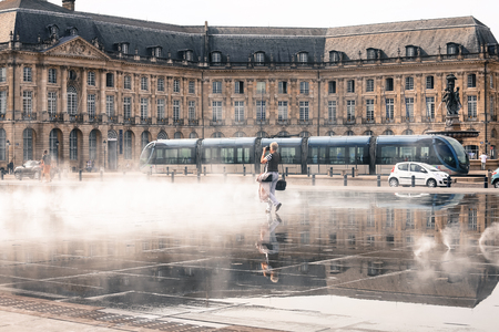 BORDEAUX, FRANCE - 3 November, 2016 : Tourist enjoy walking at Bordeaux water mirror in front of Place de Bourseのeditorial素材