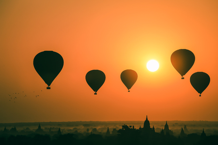 Silhouette of hot air balloon over Bagan at sunrise in misty morning, Myanmarの写真素材
