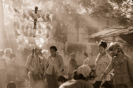BAGAN, MYANMAR - Fabruary 3, 2017 :  Morning market at Yong U Market with sun ray, this is local market selling rice, fish, vegetables, flower, clothes and souvenirs, grain texture style, sepia toneのeditorial素材
