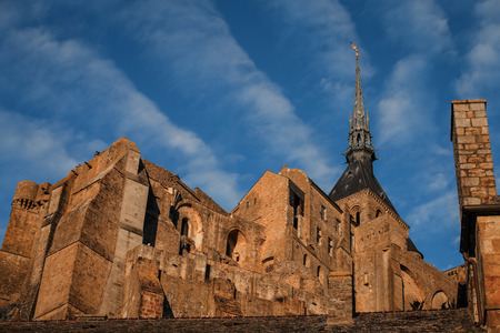 Le Mont Saint-Michel is a rocky tidal island in Normandy with blue sky, it is one of the most visited tourist sites in France.の写真素材