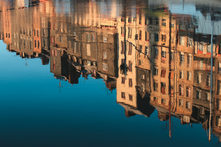 Reflection of colourful  buildings in water at  Honfleur port, France , Abstract background