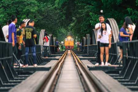 KANCHANABURI, THAILAND - JULY 9, 2016: Tourists taking pictures the train on the bridge over the river Kwai in Kanchanaburi, Thailand. This bridge is famous for its history in second world war.のeditorial素材
