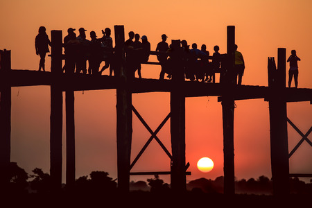 Silhouette during sunset at U Bein Bridge, Mandalay, Myanmar, grain texture style