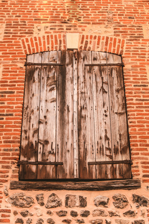 Wooden windows in a brick wallの写真素材
