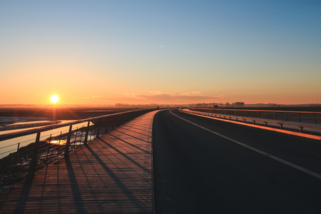 Sunrise or sunset over the bridge at Mont Saint Michel, Franceの写真素材