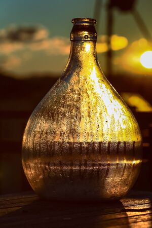 The large glass bottle with drops of water in vintage styleの写真素材