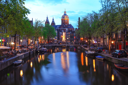 Canal and St Nicolas Church in Amsterdam at twilight, Netherlandsの写真素材