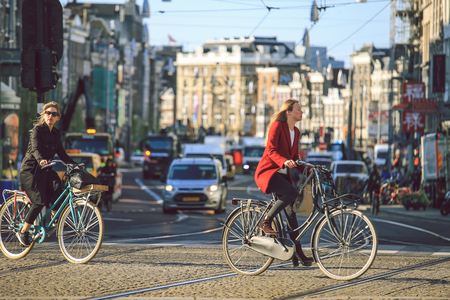Amsterdam-Netherlands, April 15, 2017 : People riding bicycles in historical part of Amsterdam in a beautiful summer dayのeditorial素材