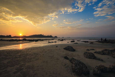 Selective focus on the sun during the sunset on the seaの写真素材