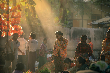BAGAN, MYANMAR - Fabruary 3, 2017 :  Morning market at Yong U Market with sun ray, this is local market selling rice, fish, vegetables, flower, clothes and souvenirs, grain texture styleのeditorial素材