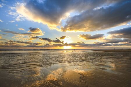 Colourful sunset over sea with it's reflection as backgroundの写真素材
