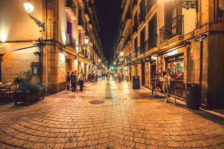 SPAIN SAN-SEBASTIAN - OCTOBER 27.2017 : San Sebastian typical small street view with lively tapas bars and restaurants at nightのeditorial素材