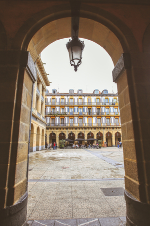 SPAIN SAN-SEBASTIAN - OCTOBER 27, 2017 : Selective focus on classic street lamp with colourful buildings as background at constitution Square in Spainのeditorial素材