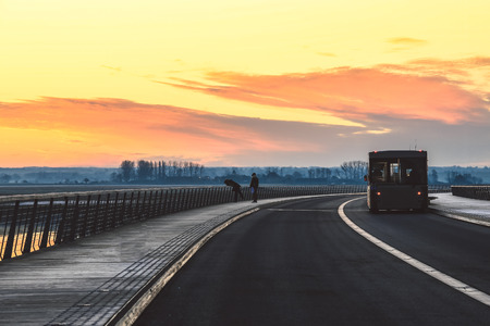 Bridge over bay in Mont Saint Michel during sunrise or sneset, Franceの写真素材