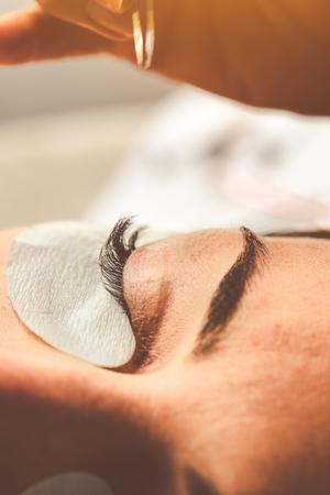 Eyelash Extension Procedure. Woman Eye with Long Eyelashes. Lashes. Close up, macro, selective focus