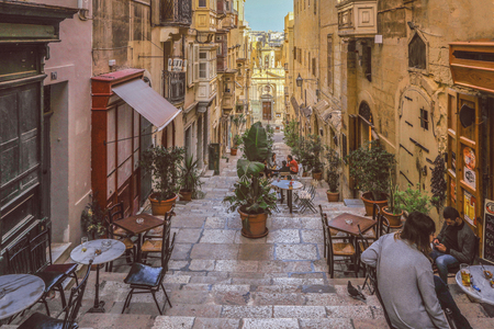Valletta Malta - April 1 2018 : Tiny cafes with tables on stairs of narrow street,Valletta, Maltaのeditorial素材