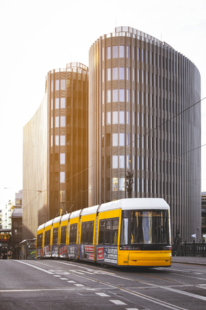 BERLIN GERMANY - JANUARY 1, 2018: Yellow  public transportation tram passing by the city of Berlin Germanyのeditorial素材