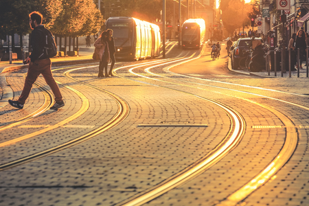 BORDEAUX, FRANCE- October 1, 2017 : City street scene, people walking on street with tramway during the sunset in Bordeaux, Franceのeditorial素材