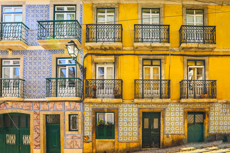 Facade of traditional houses with entrance doors, balconies and windows. Lisbon, Portugalの写真素材