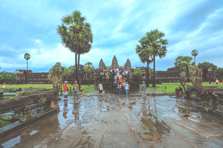 Siem Reap, Cambodia - March 22, 2018 : Tourists visiting Angkor Wat temple under the rain in Siem Reap. Angkor Wat is the largest religious monument in the world.のeditorial素材