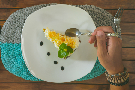 hand eating coconut cakeの写真素材