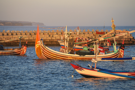Colorful handcrafted Balinese wooden fishing boat at port in Jimbaran beach, Baliのeditorial素材