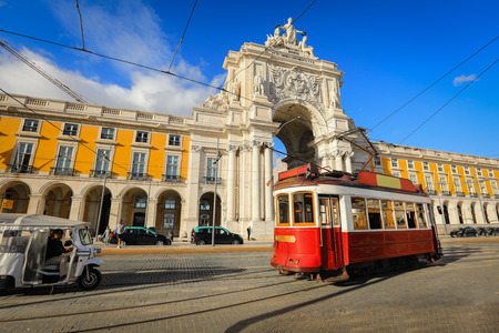 LISBON - PORTUGAL, November 5, 2018: Touristic tram at Praca do Comercio (Commercial Square) near Triumphal Arch of Rua Augusta. Sunny day in famous tourist place of Lisboa.のeditorial素材