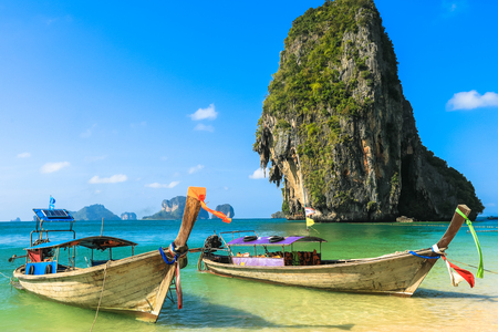 Tropical beach with traditional long tail boats on Kho Poda, Khabi, Thailandの写真素材