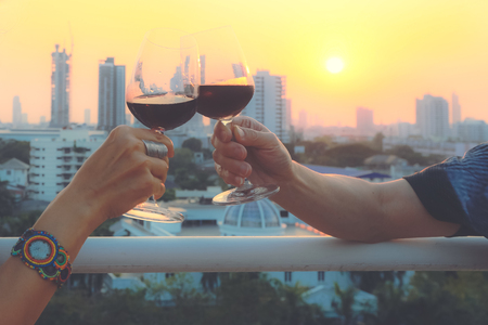 Attractive young asian woman drinking red wine on terrace with friend, vintage styleの写真素材