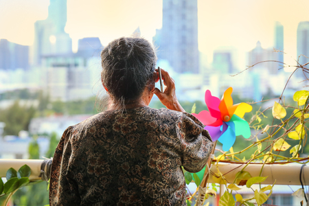 close up hand of old asian woman hold smartphoneの写真素材