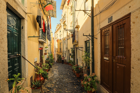A narrow street in Alfama district in Lisbon, Portugalの写真素材