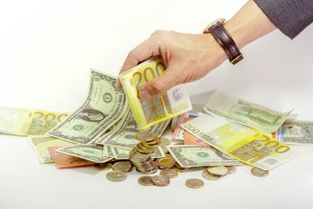 business manâs hand holding 200 euro currency and coinsの写真素材
