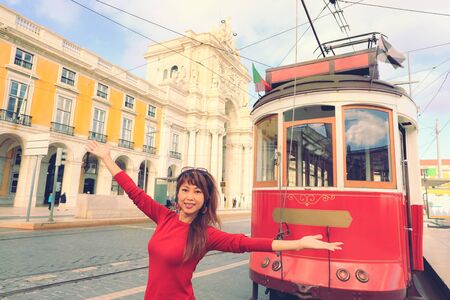 Young asian tourist standing in front of   traditional tram in Lisbon, Portugalの写真素材