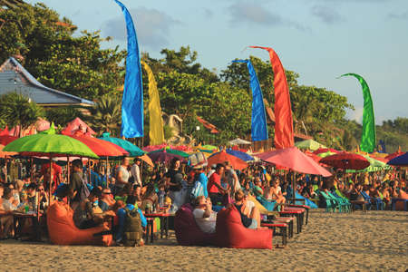 Bali - Indonesia - February 5, 2020 :  Tourists enjoy their vacation on Kuta beach at Bali, Indonesia.のeditorial素材