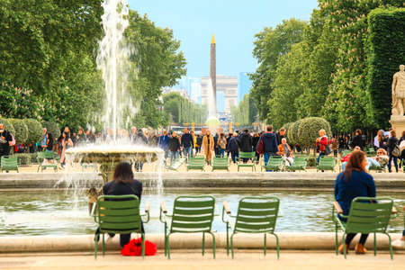 Paris, France - June 17, 2019: Selective focus on Obelisk and triumphal arch with tourists enjoy the vacation at the Tuileries Garden in Parisのeditorial素材