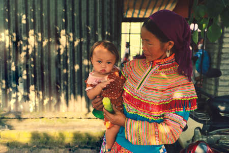 Mu cang chai, Vietnam-July 20, 2019: Hmong tribe woman carrying her child in Mu cang chai Northern Vietnamのeditorial素材