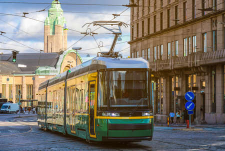 green tram transporting people in the central part of the Helsinki city, Finlandのeditorial素材