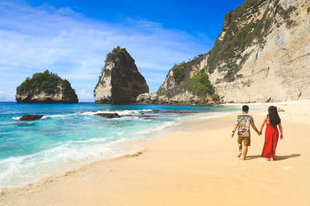 Back side of couple walking on Diamond beach in Nusa penida island, Bali in Indonesia.のeditorial素材
