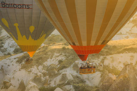 Cappadocia, Turkey - October 19, 2019 :  Tourists enjoy hot air balloon flights in Cappadocia. Hot air balloons are traditional touristic attraction in Cappadocia.のeditorial素材