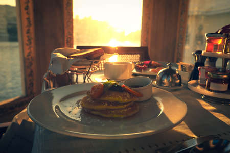 Breakfast time in luxury Hotel with pancake and fruit salad as topingの写真素材
