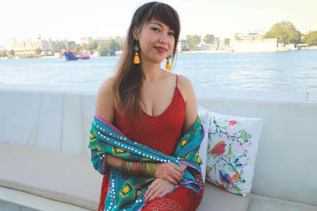 Pretty Thai woman sitting on the bank of the river, healthy life conceptの写真素材