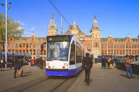 Amsterdam-Netherlands, April 15, 2017 : Tram waiting in front of the central station in Amsterdam the Netherlands, vintage styleのeditorial素材
